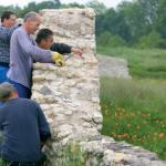 Ouvriers en train de consolider un mur de pierre